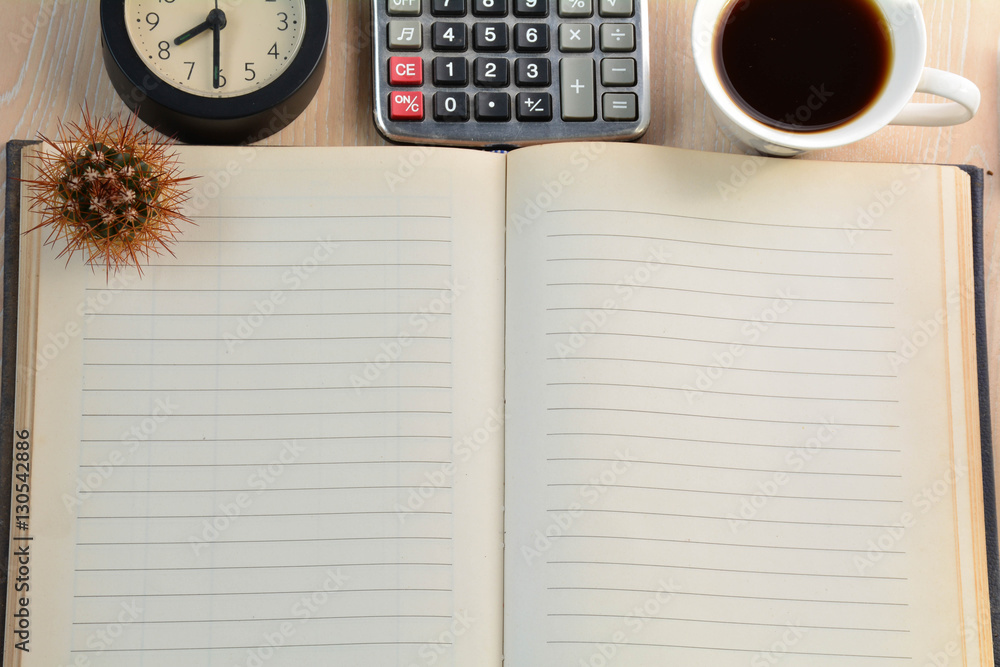 Cactus, clock, calculator and coffee cup on the table. Cactus, clock, calculator and coffee cup on the table.