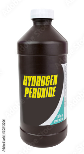 Brown plastic bottle of hydrogen peroxide. Isolated. Vertical. photo