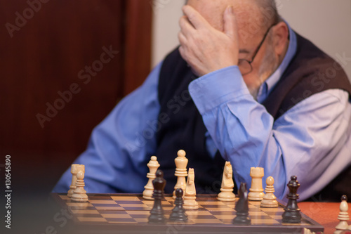old man losing chess match 
