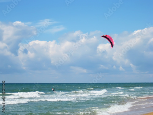 Man on kiteboard in ocean