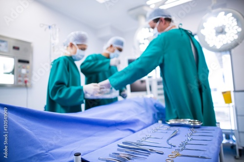 Fotografie, Obraz Surgeons performing operation in operation theater