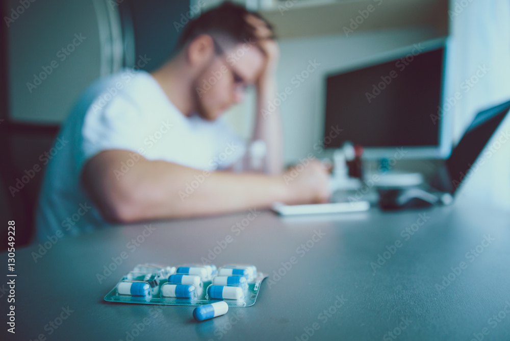 man sitting and looking on pills man sitting and looking on pills