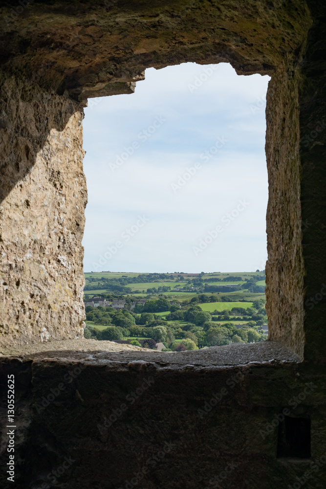 View of British countryside though window of traditional stone b