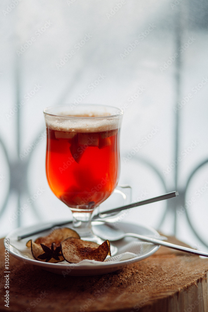 Glass of delicious cherry glintwein or mulled hot wine thread on vintage wooden background Glass of delicious cherry glintwein or mulled hot wine thread on vintage wooden background