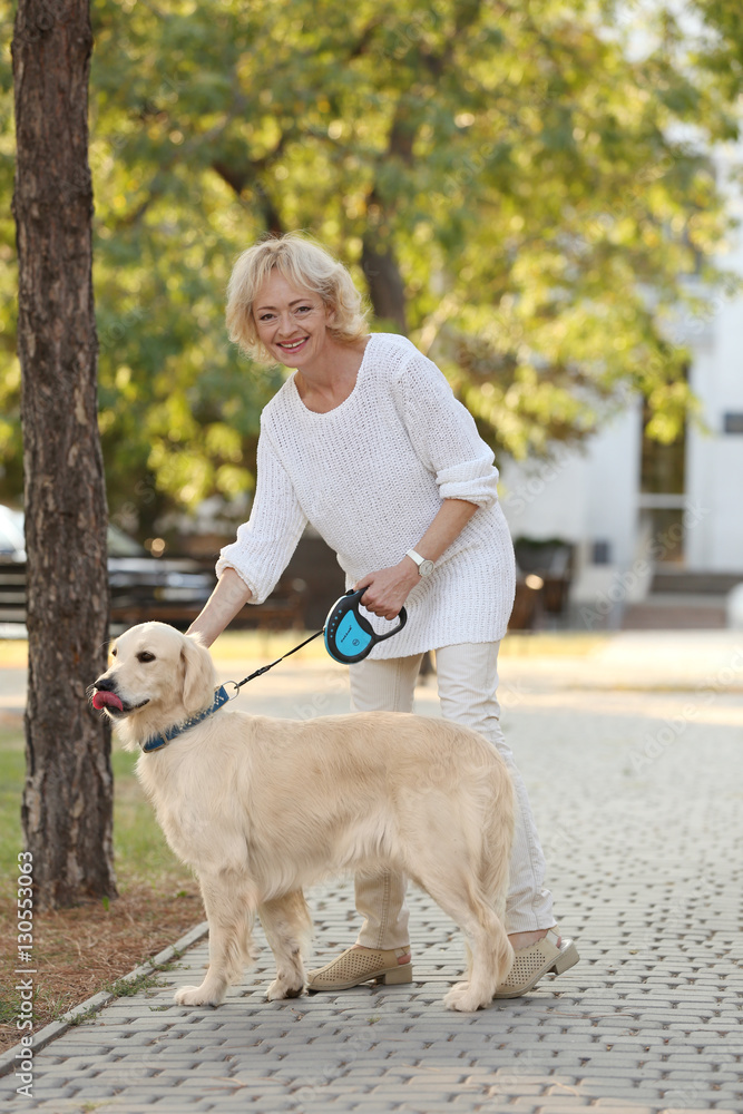 Senior woman with big dog in park Senior woman with big dog in park