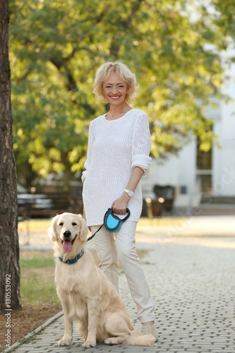Senior woman with big dog in park