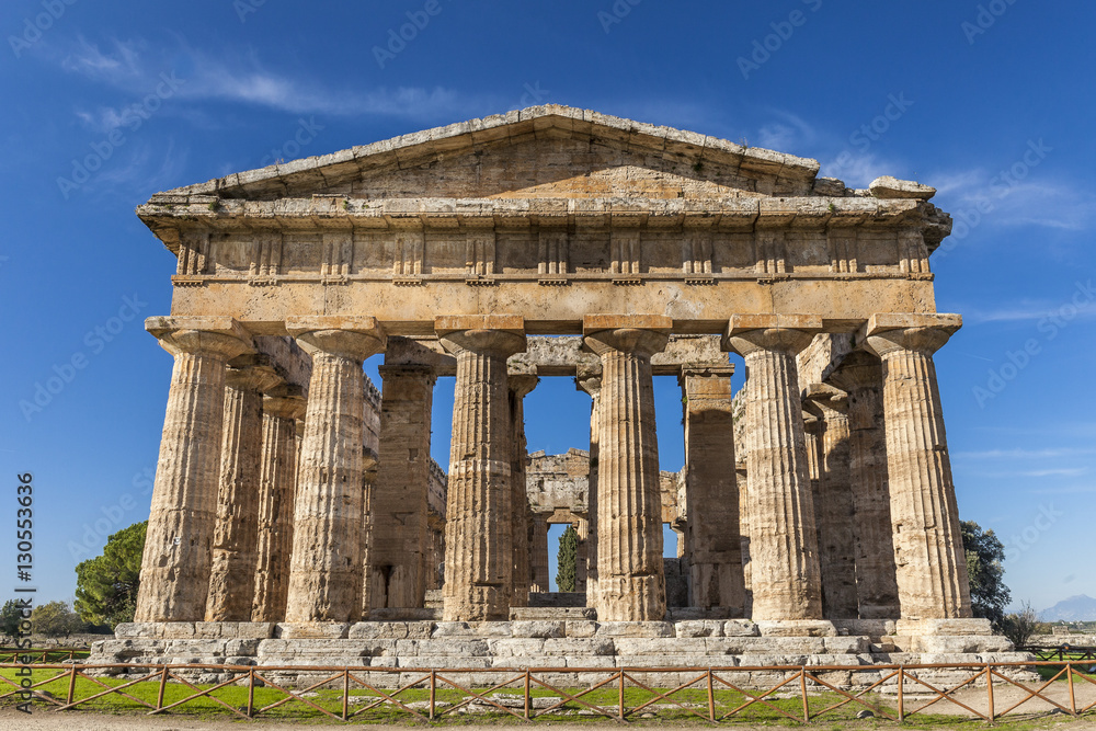 Front view of greek temple of Neptune, in the archaeological site of Paestum, Salerno, Italy