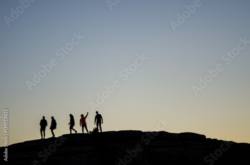 A group of friends taking a selfie at dusk