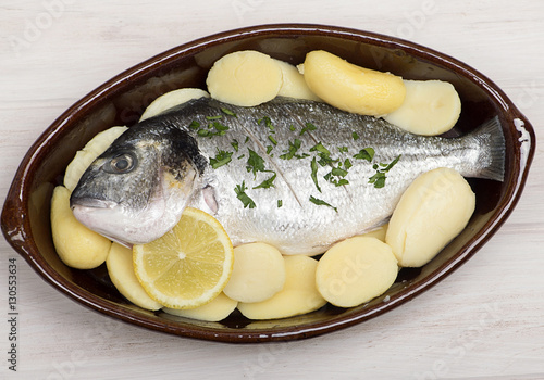Canvas Print Raw fish with potatoes is about to be cooked