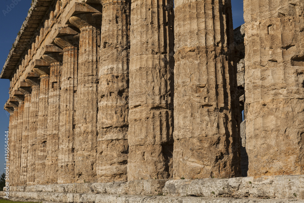 Fototapeta premium Close up of columns of greek temple of Neptune, in the archaeological site of Paestum, Salerno, Italy