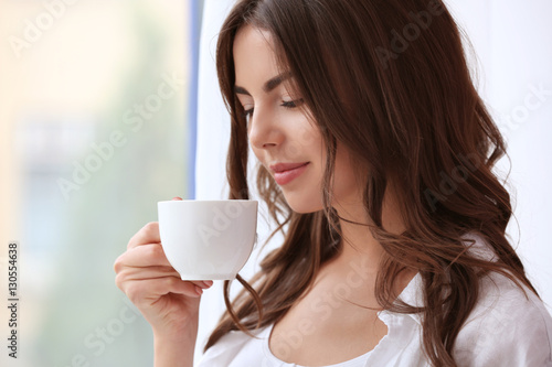 Beautiful woman with cup of...