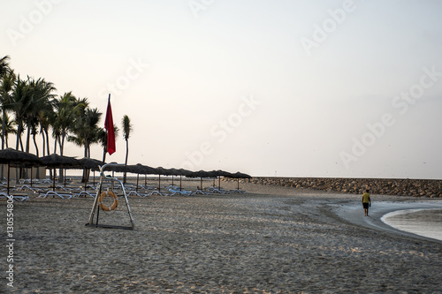 Flag no swimming danger sign at beach souly bay salalah Oman photo