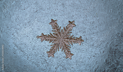 Christmas snowflake on ice background