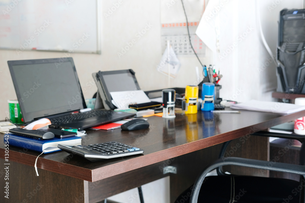 office table with PC and different stationery on it office table with PC and different stationery on it
