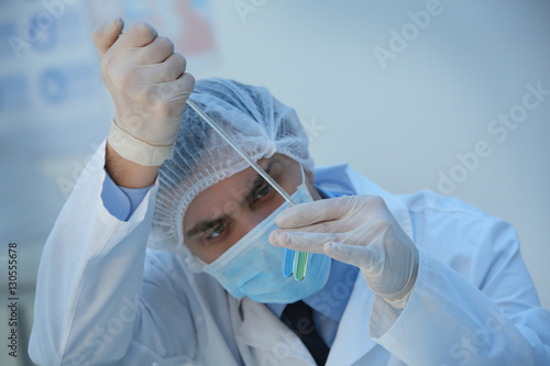 Young male scientist making...