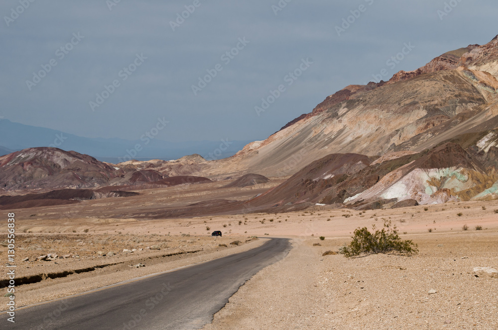 Desert landscape, narrow road and geologic formation called Artist's Palette in the scenic Artist Drive, the Death Valley National Park, CA