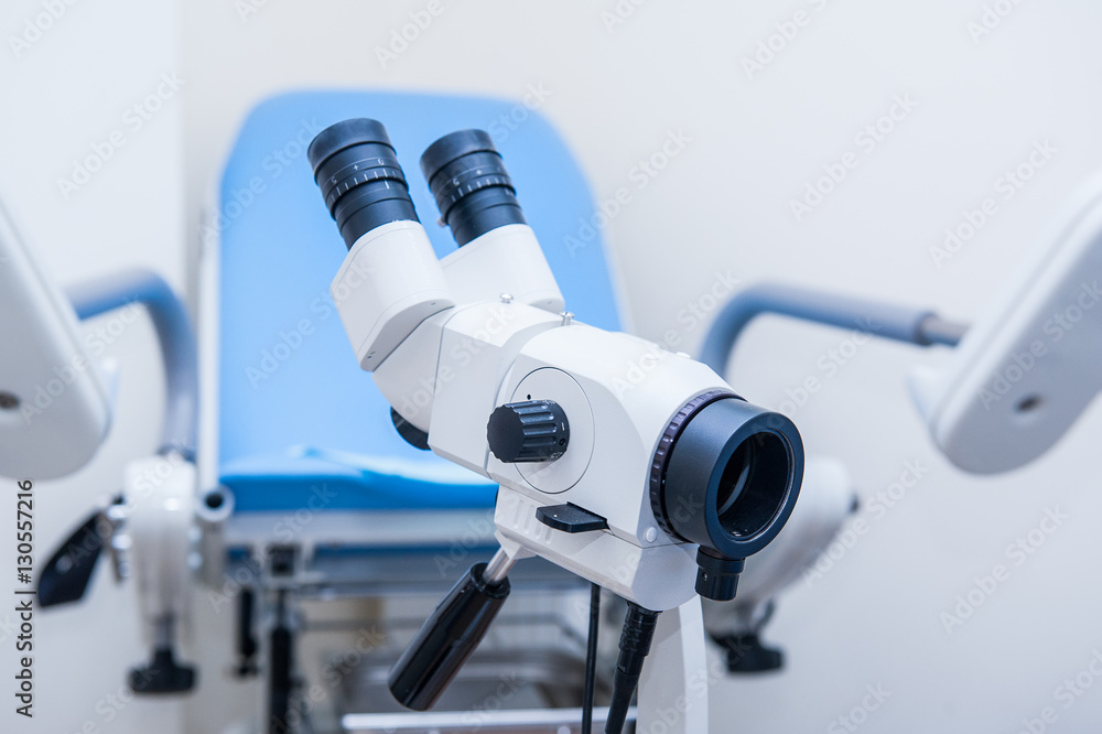 Close up colposcope on the background of gynecological chair Close up colposcope on the background of gynecological chair
