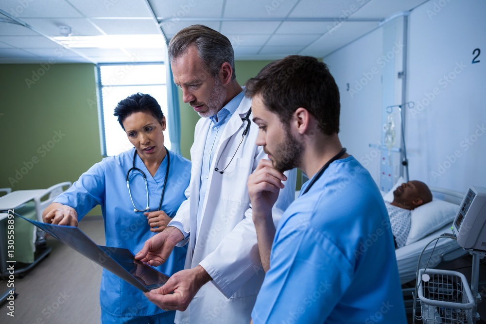 Doctor and nurse discussing x-ray in ward Doctor and nurse discussing x-ray in ward