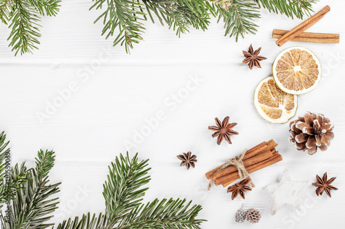 Christmas white wooden background with fir branches top view. Sp