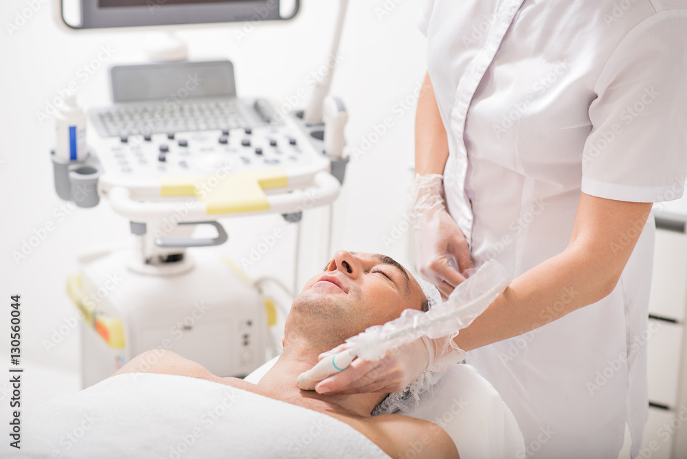 Female cosmetologist undergoing laser therapy Female cosmetologist undergoing laser therapy