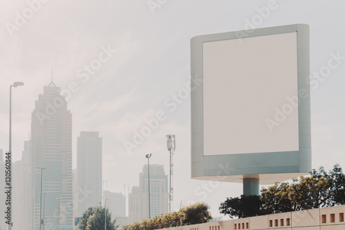 Photography Mock up of blank vertical white advertising billboard in Dubai with residential