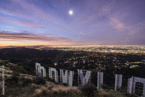 High angle view of Hollywood sign by illuminated city at dusk