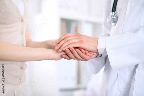 Hand of doctor reassuring her female patient © rogerphoto