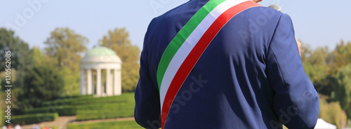 Italian mayor with the tricolor flag at a public event outdoors photo