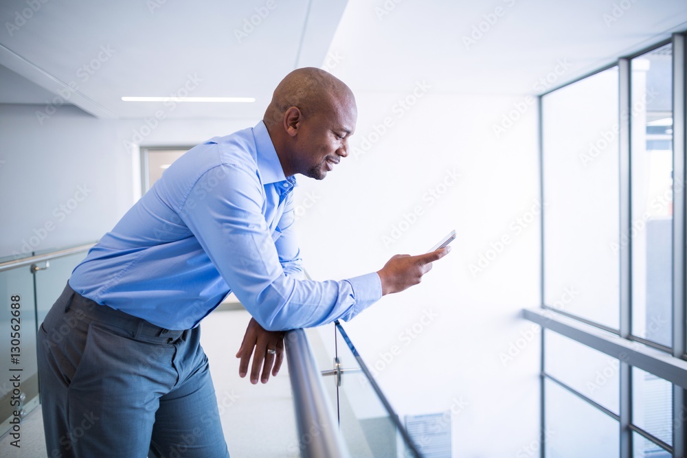 Doctor using mobile phone in corridor Doctor using mobile phone in corridor