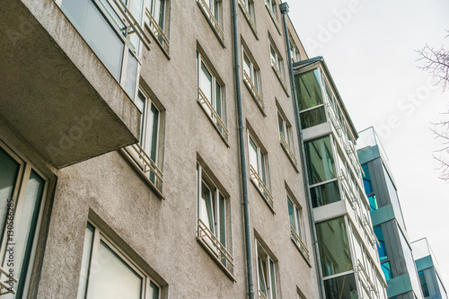 typical berlin apartment houses with stone and glass facade