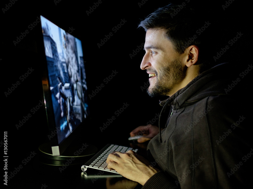 Happy man playing videogame on desktop computer Happy man playing videogame on desktop computer