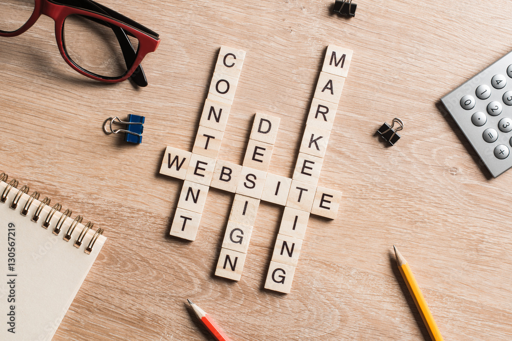 Conceptual business keywords on table with elements of game making crossword Conceptual business keywords on table with elements of game making crossword