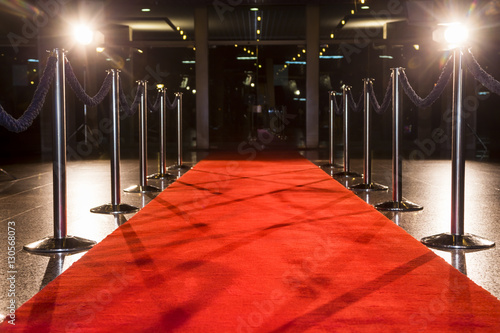 Long red carpet between rope barriers on entrance.