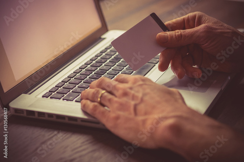 Man typing on a laptop keyboard photo