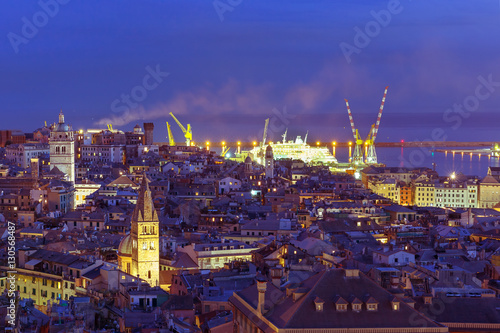 Aerial view of old town and port with cranes at night  Genoa  Italy.