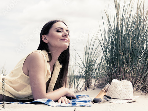 Woman resting on beach.