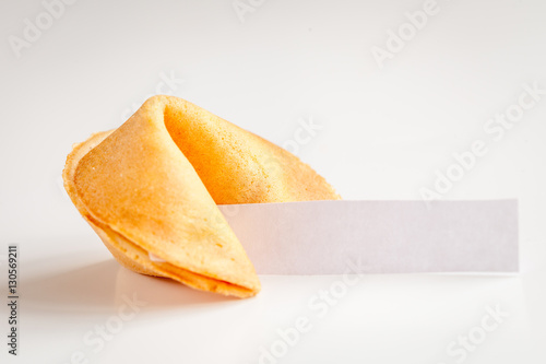 Chinese fortune cookie with prediction on white background