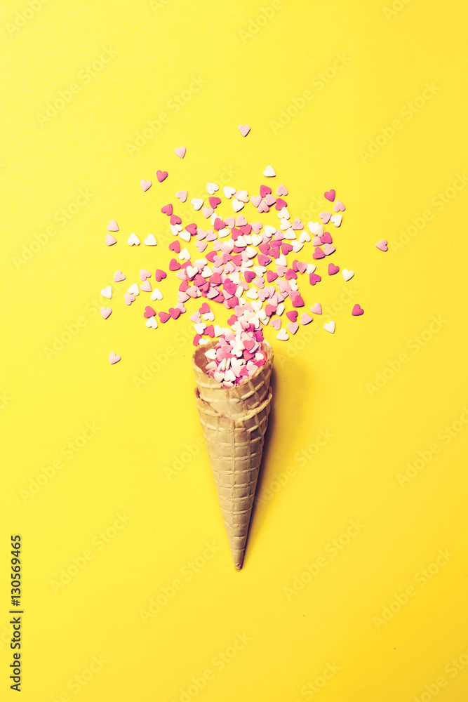 Ice Cream Horn or Cone with Sweethearts on a Yellow Background.