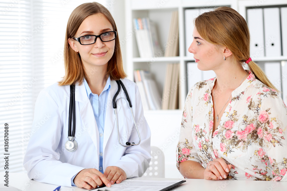 Doctor and patient sitting at the desk Doctor and patient sitting at the desk