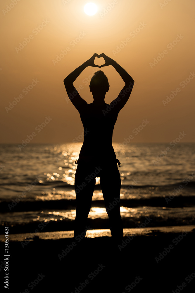 Female Silhouettes Hands Making a Heart Shape