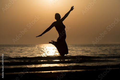 Siluet Woman With Raised Hands And Jumping Around