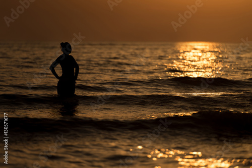Silhouette Woman on the Sea Beach at Sunset © Jale Ibrak