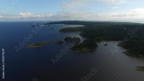 Flying over the rugged coast of the island of Valaam. Ladoga lake. Journey to the Holy places. Aerial view. The landscape of the island of Valaam. photo