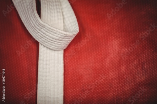 Karate white belt on red background