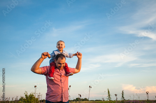 Cute boy with dad playing outdoor