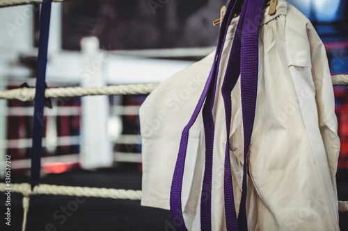 Karate uniform and purple belt in boxing ring