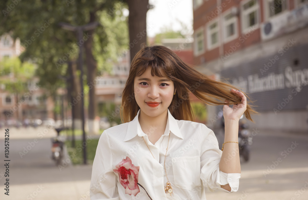 Young asian woman in campus and looking at camera Young asian woman in campus and looking at camera