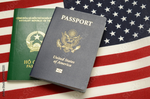 United states of america passport and vietnamese passport on us flag background