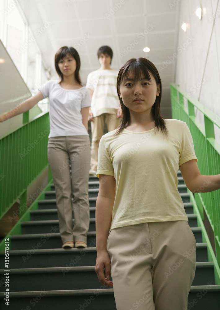 Young people standing on stairs Young people standing on stairs