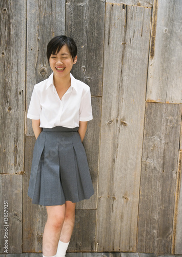 Smiling teenage girl in school uniform © imagenavi